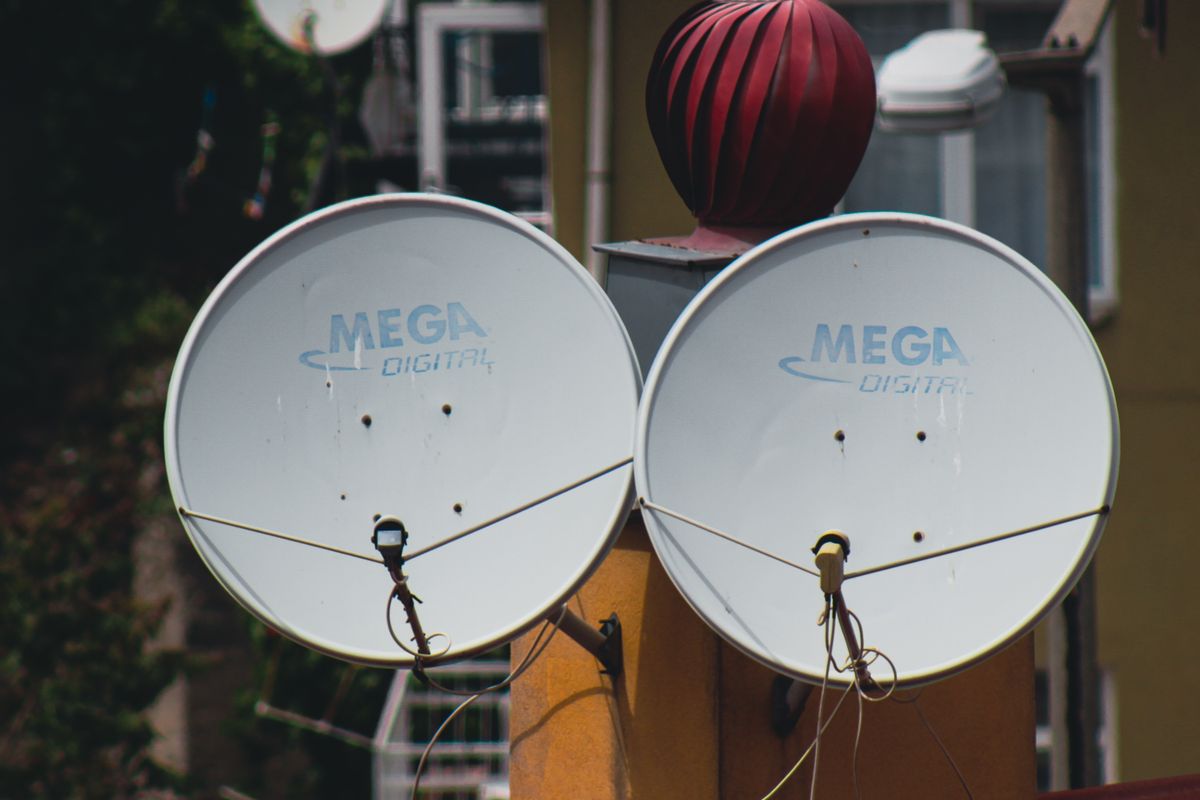 Satellite dishes on rooftops across a residential area